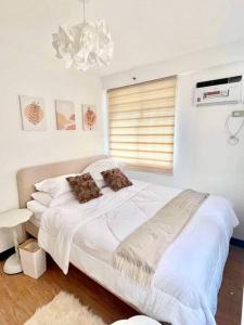 Postel nebo postele na pokoji v ubytování Balay Bahandi Condominiums