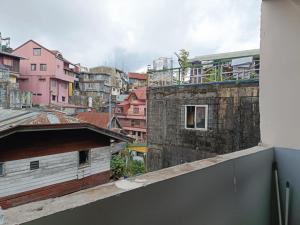 a view of a city from the balcony of a building at The Touch Affordable Baguio Apt in Baguio