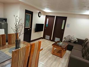 a living room with a couch and a table at The Touch Affordable Baguio Apt in Baguio