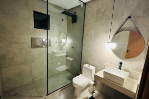 a bathroom with a shower and a toilet and a sink at COC00N HOUSE - Vale do Capão in Palmeiras