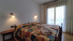 Postel nebo postele na pokoji v ubytování Apartaments Les Dunes
