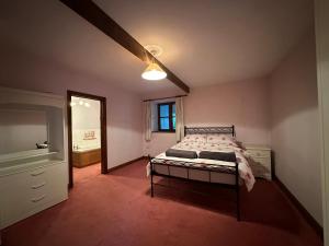 Un dormitorio con una cama y un ventilador de techo. en The Old Dairy, en Chepstow