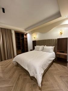 a large white bed in a hotel room at Centrico 13 Confort & Luxe au Centre in Tangier