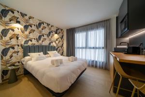 a hotel room with a bed and a desk at Alicante Smart Accommodation in Alicante +87 photos