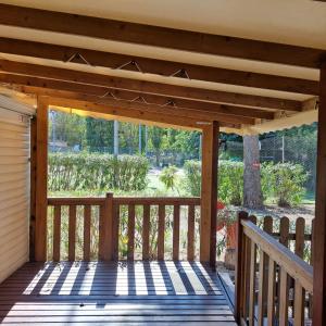a wooden porch with awning on a house at Sable d'or in Le Grau-dʼAgde