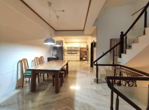 a dining room with a wooden table and chairs at 金色水岸 #台南運河電梯民宿#可包棟 in Tainan