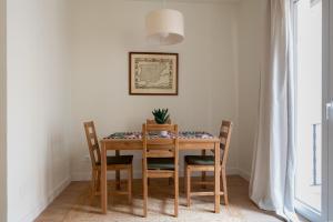 a dining room table with chairs and a plant on it at Sweet Home Santander in Santander +23 photos