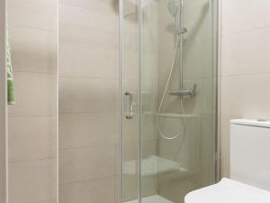 a shower with a glass door in a bathroom at Sweet Home Santander in Santander