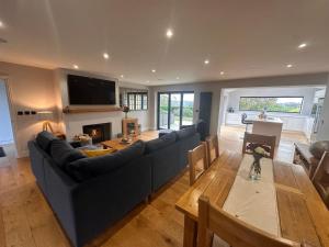a living room with a couch and a table at Spectre Hot Tub Retreat - Harrogate in Pannal