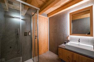 a bathroom with a glass shower and a sink at DALANIA MOUNTAIN APARTMENTS in Ponte di Legno +82 photos