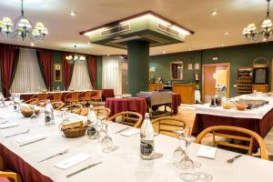 a dining room with tables and chairs with wine bottles at Zenit Logroño in Logroño