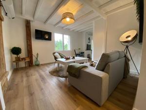 a living room with a couch and a table at Gîte Rénové en bordure de forêt in Laveline