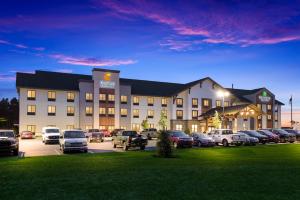 a large building with cars parked in a parking lot at Comfort Inn & Suites Gaylord in Gaylord