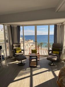 a room with chairs and a view of the ocean at Penthouse Giner Benidorm centro playa by TRG in Benidorm