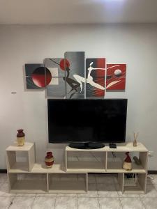a flat screen tv sitting on top of a white cabinet at Espacio Seven Mendoza in Guaymallen