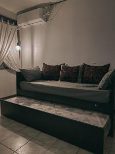 a couch in a room with pillows on it at Espacio Seven Mendoza in Guaymallen +23 photos
