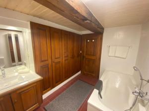 a bathroom with a white tub and a sink at La Grande Majorie de Nendaz in Nendaz +34 photos