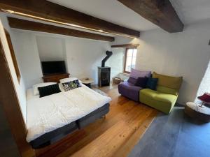 a bedroom with a bed and a couch at La Grande Majorie de Nendaz in Nendaz