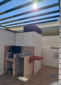 a bathroom with a sink in a brick wall at Ático con terraza, piscina y jacuzzi in Villanueva de Río Segura +25 photos