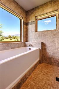a bathroom with a tub and a window at Mountain Sanctuary in Livingston +16 photos