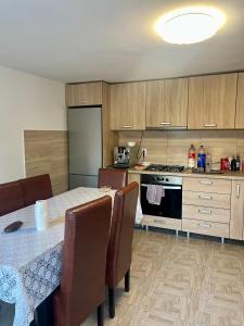 a kitchen with a table and chairs and a stove at Cabana Baraj Apuseni Mountains in Mihoeşti