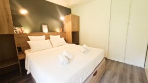 a bedroom with a bed with two towels on it at Appt Le Borgeal - rez de jardin, au calme in Les Villards-sur-Thônes