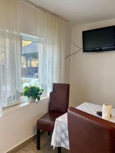 a room with a table and a chair and a window at Cabana Baraj Apuseni Mountains in Mihoeşti