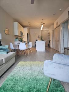a living room with a couch and a table at Beautiful Condo on Riverwalk w King Ste free parking pet friendly Centrally Located in San Antonio