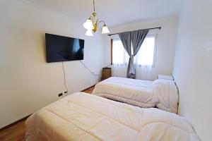 En eller flere senge i et værelse på Departamento amplio y equipado - Roca 2