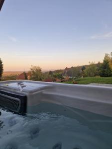 a bath tub filled with lots of water at Baráti Vendégház in Győrújbarát +40 photos