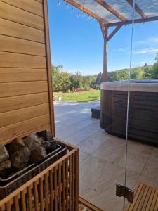 a patio with a hot tub and a grill at Baráti Vendégház in Győrújbarát