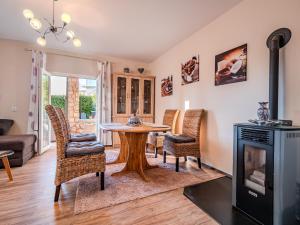a living room with a table and chairs and a fireplace at Villa Badi in Malinska