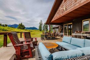 a patio with chairs and furniture on a house at Mountain Sanctuary in Livingston