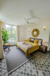 a bedroom with a bed and a large window at Presidential Luxury Villa Anjuna with Private Pool and Dedicated Caretaker in Old Goa