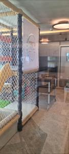 a cage in a room with a sign on it at Porto Alto in Ipojuca +36 photos
