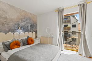 a bedroom with a bed with orange pillows at Art Hotel Vienna in Vienna