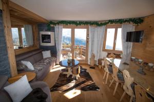 a living room with a couch and a table at Le Bristol - Villars Bristol Apartments in Villars-sur-Ollon