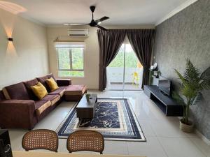 a living room with a couch and a table at De Home Desaru Luxury Suite Near Beach 3Pax D13A05 in Bandar Penawar