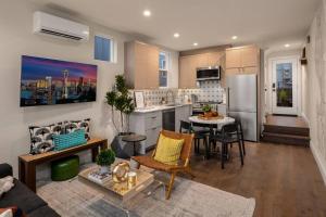 a kitchen and living room with a couch and a table at New House in peaceful and trendy Central District in Seattle