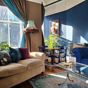 a living room with a couch and a table at The Huntress Suite in Buxton