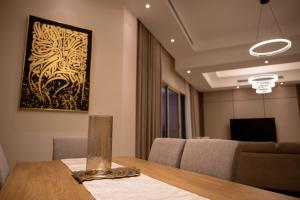 a dining room with a table and a painting on the wall at أبحر ريزيدينس804 in Obhor