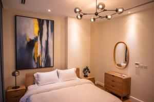 a bedroom with a bed and a painting on the wall at أبحر ريزيدينس804 in Obhor