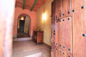 a room with wooden lockers and a mirror at Casa del Río by SIERRA VIVA in La Nava