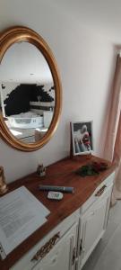a mirror sitting on top of a dresser with a counter at Love room avec spa privatif in Saint-Amarin