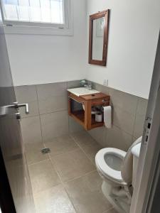 a bathroom with a toilet and a sink at La Mary in Mar del Plata