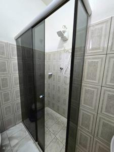 a glass shower in a bathroom with a toilet at Pousada Padre Toledo in Tiradentes +22 photos