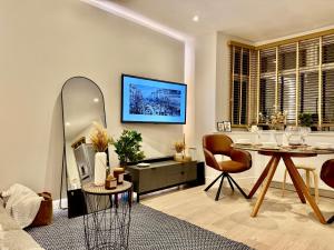 a living room with a table and a mirror at Superb Duplex in North London with reserved parking in The Hyde