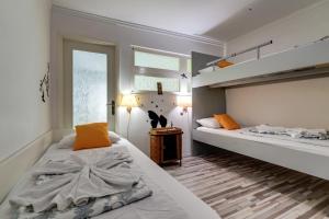 a bedroom with two beds and a window at Apartments Coli app Afrodita & Antonia & Veronika in Bakar