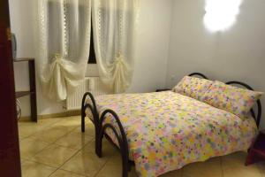 Pensiunea Lui Nea Nicu Lepsa في ليبسا: غرفة نوم مع سرير مع لحاف ملون