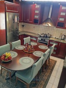 una cocina con una mesa de madera con sillas y un asterisco en Three Goods Trikala Meteora, en Tríkala